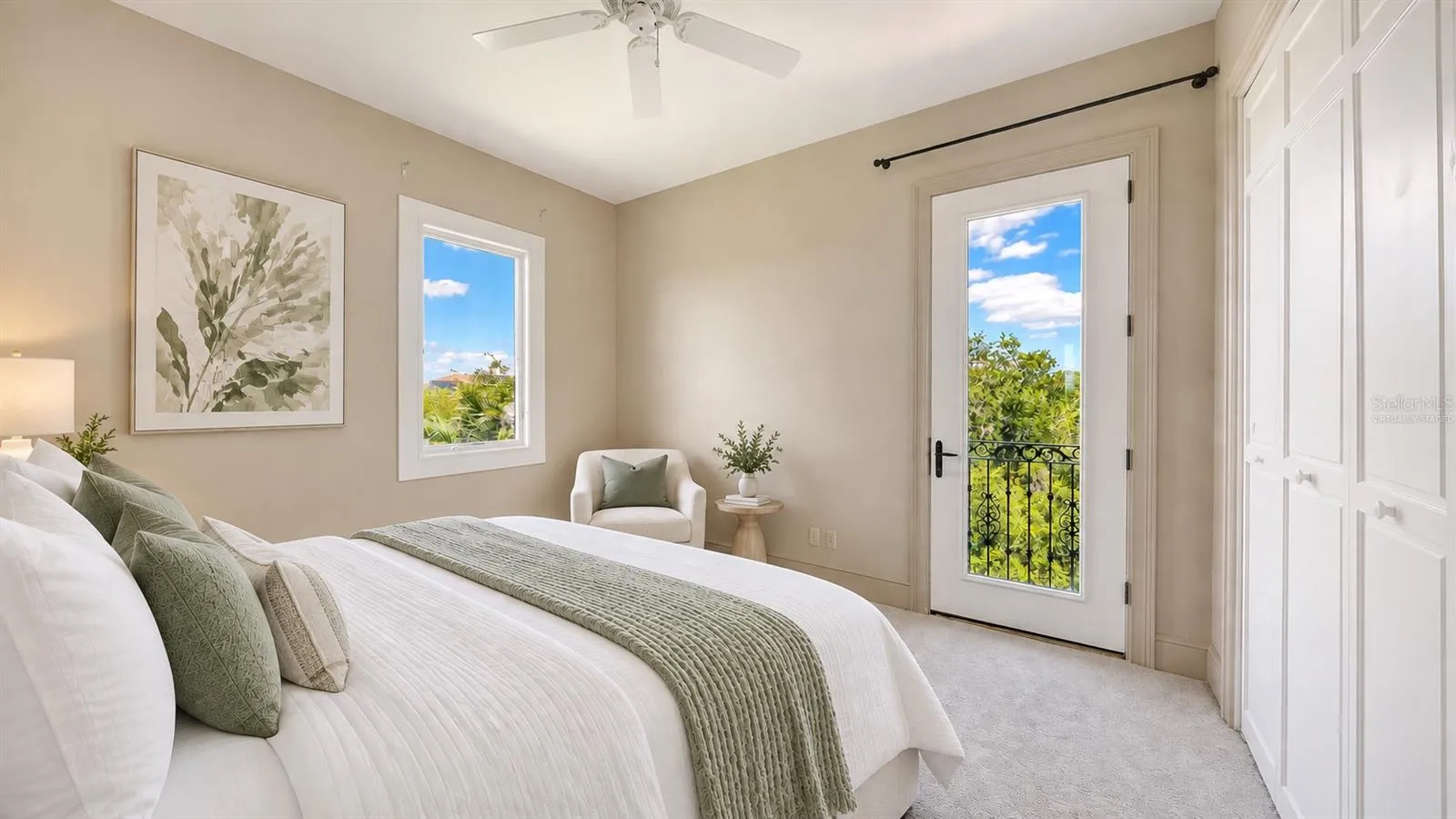 Bedroom Three (Virtually Staged) features a balcony with surrounding greenery in this peaceful and private upper level bedroom.