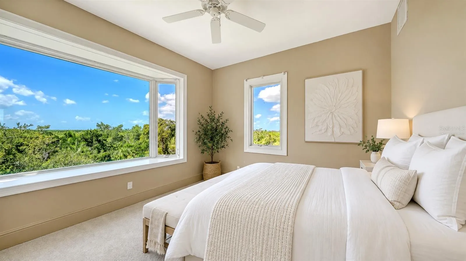 Bedroom Two (Virtually Staged) is a bright and inviting secondary bedroom enjoys beautiful treetop views and abundant natural light.