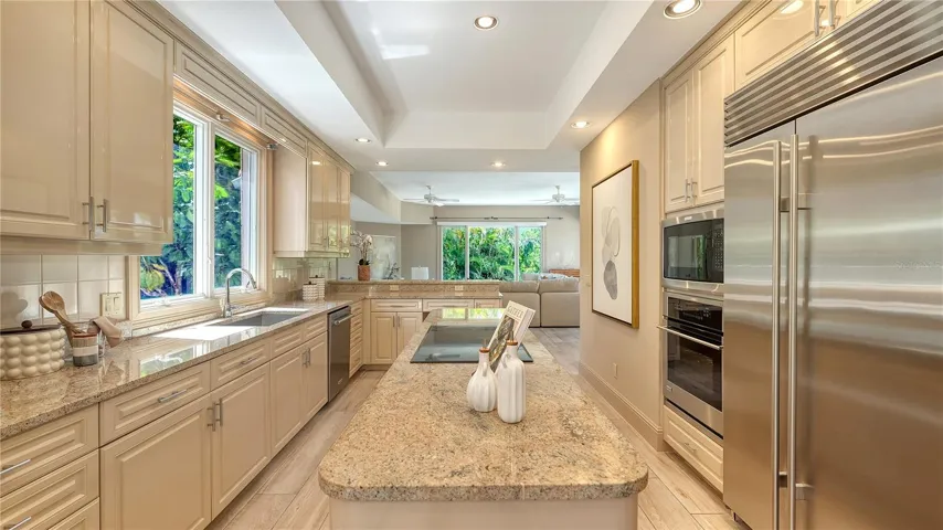 Stone countertops, generous cabinetry and premium appliances combine function with timeless design.