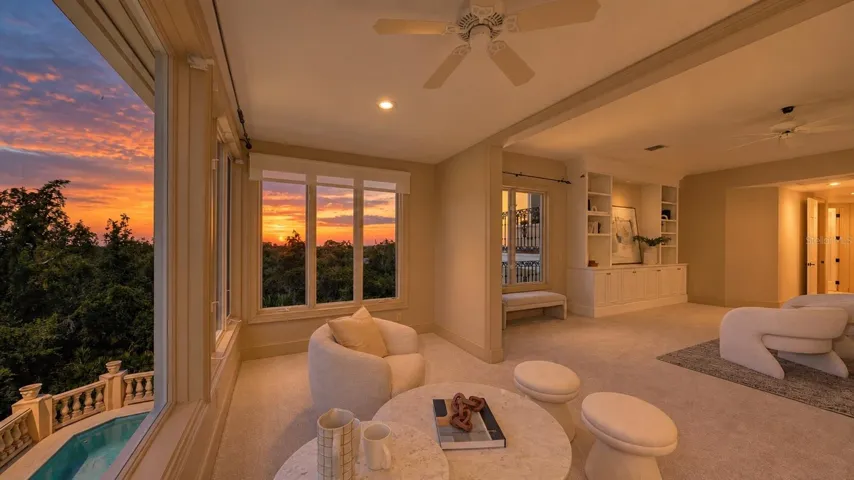 The primary sitting area captures the warm glow of sunset over the surrounding coastal landscape.