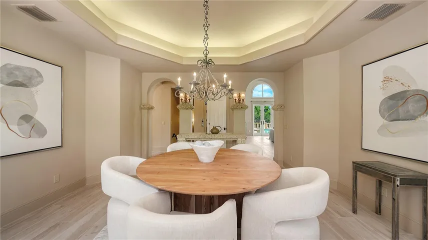 The dining room's graceful proportions and architectural detailing create an inviting space for memorable gatherings.