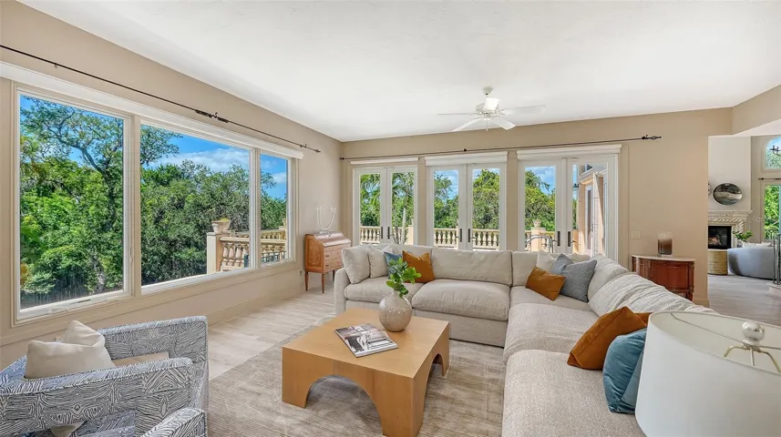French doors and oversized windows bring the beauty of the surrounding landscape into the home's main gathering areas.