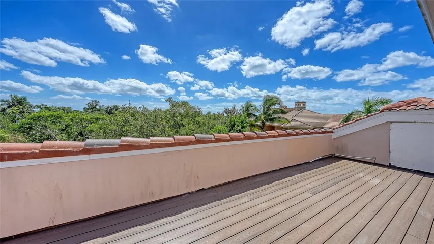 An expansive rooftop terrace creates a remarkable outdoor vantage point above the surrounding treetops.