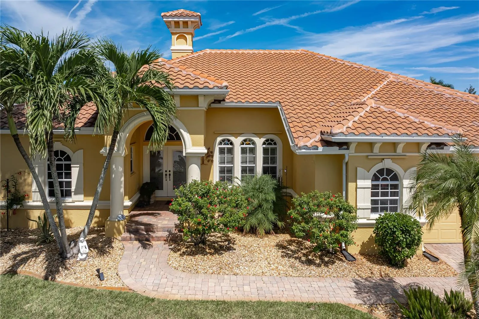 Well-maintained landscaping and brick paver walkway