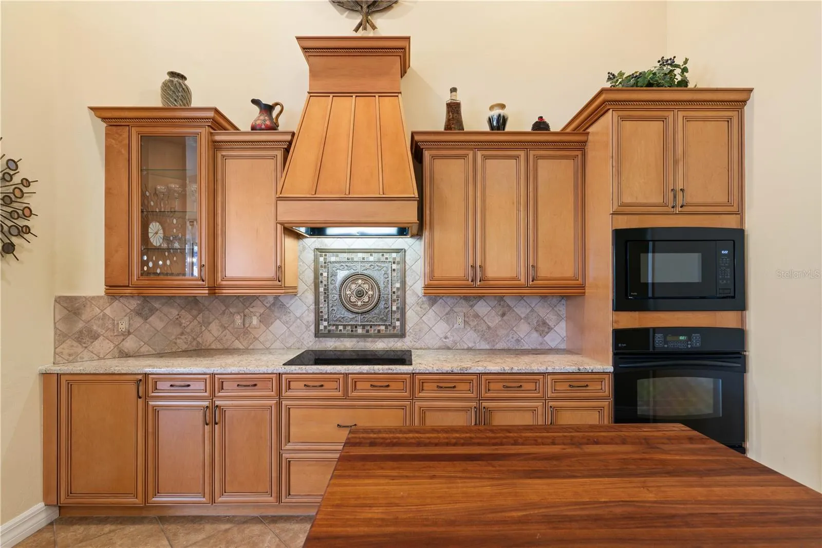 Kitchen has center island w/butcher block counter