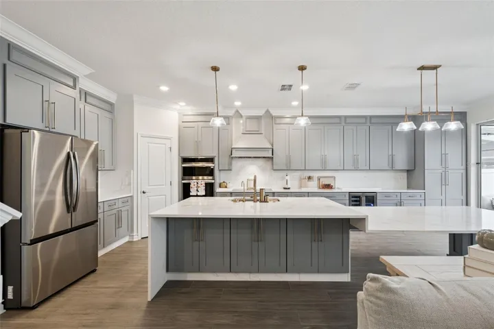 Different kitchen angles showing the abundance of custom cabinets