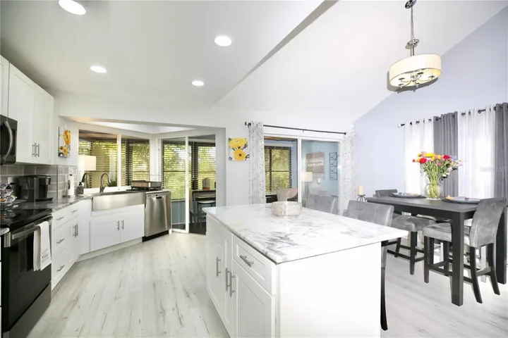 kitchen island, dining area and double doors to the indoor setting area
