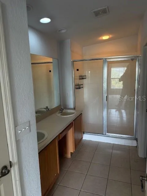 Primary Bath with Double Sink and private toilet room.