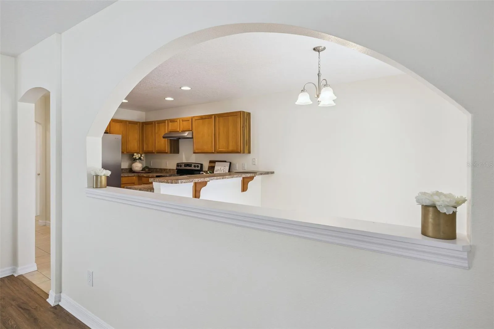 Arched pass-through connecting the family room to the breakfast nook and kitchen