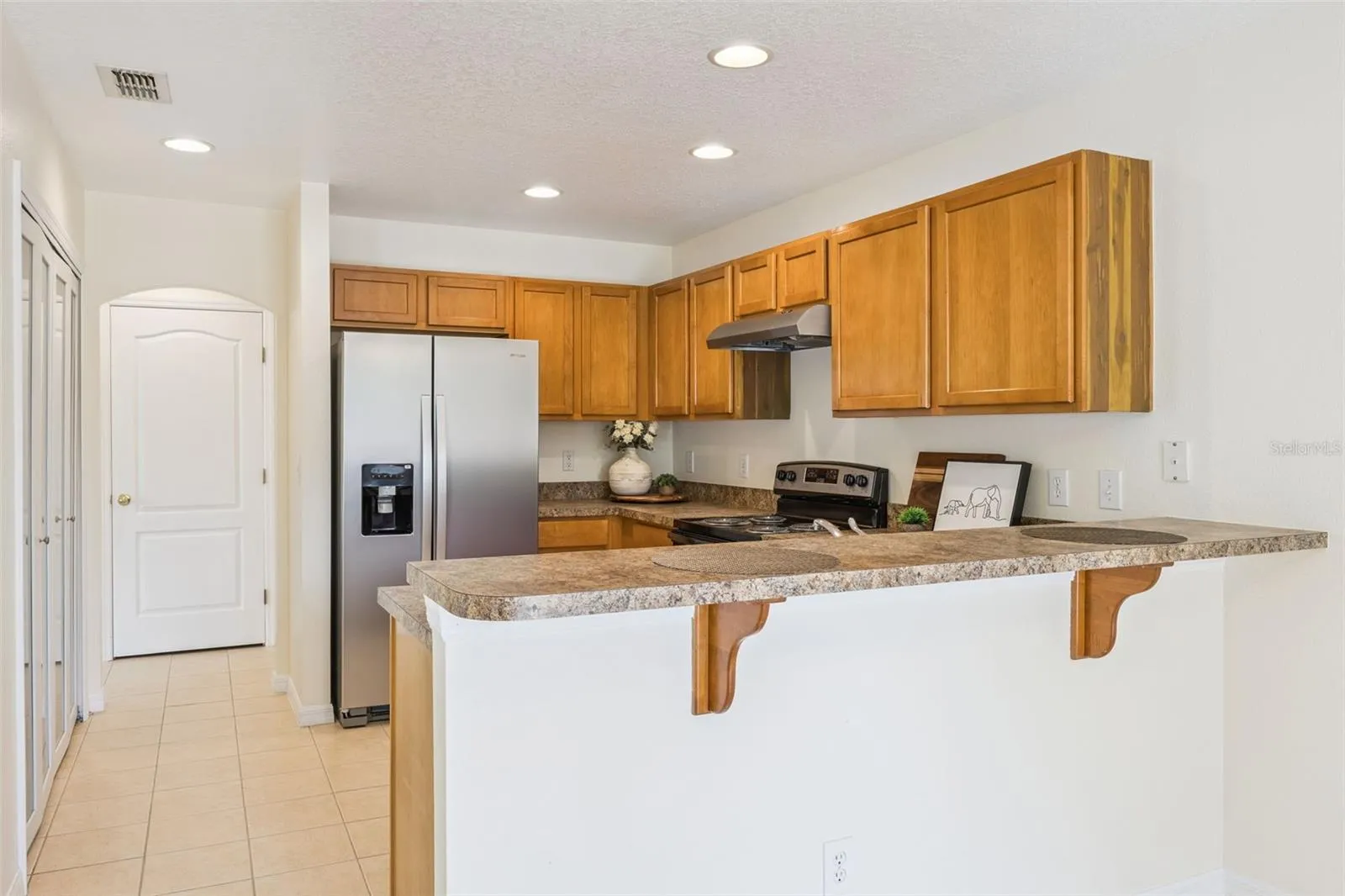 Kitchen with breakfast bar and stainless steel appliances