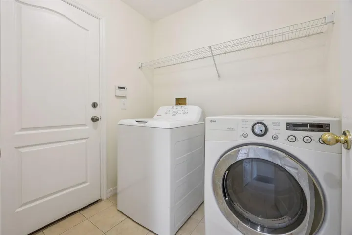 Laundry room (6'2" x 6'8") with washer, dryer and new wire shelving