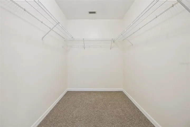 Primary walk-in closet (6'4" x 8'11") with new wire shelving