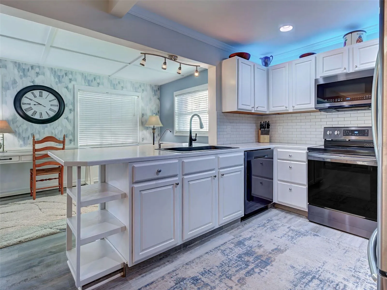 Well laid out kitchen has plenty of prep space and flows to sunny bonus room.