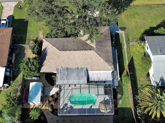 Eagle's view of beautiful 3035 Lobelia with over-sized lanai, shed with 3rd bedroom and mature landscaping.