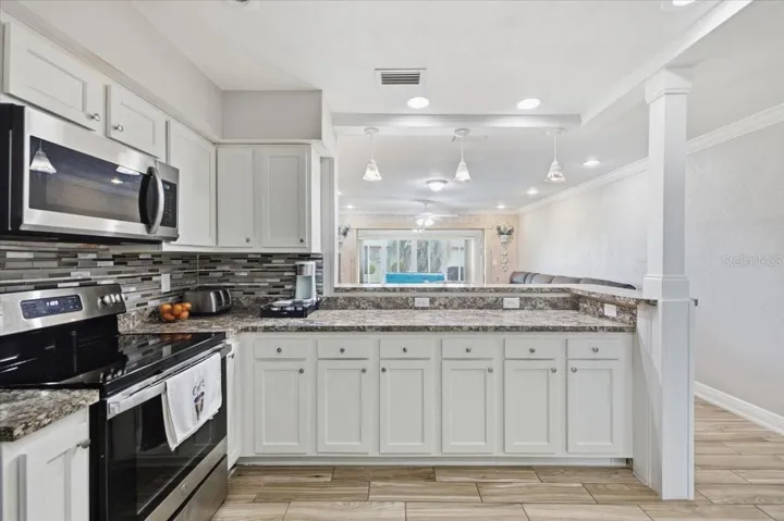 Kitchen view into Family Room and Sun Room
