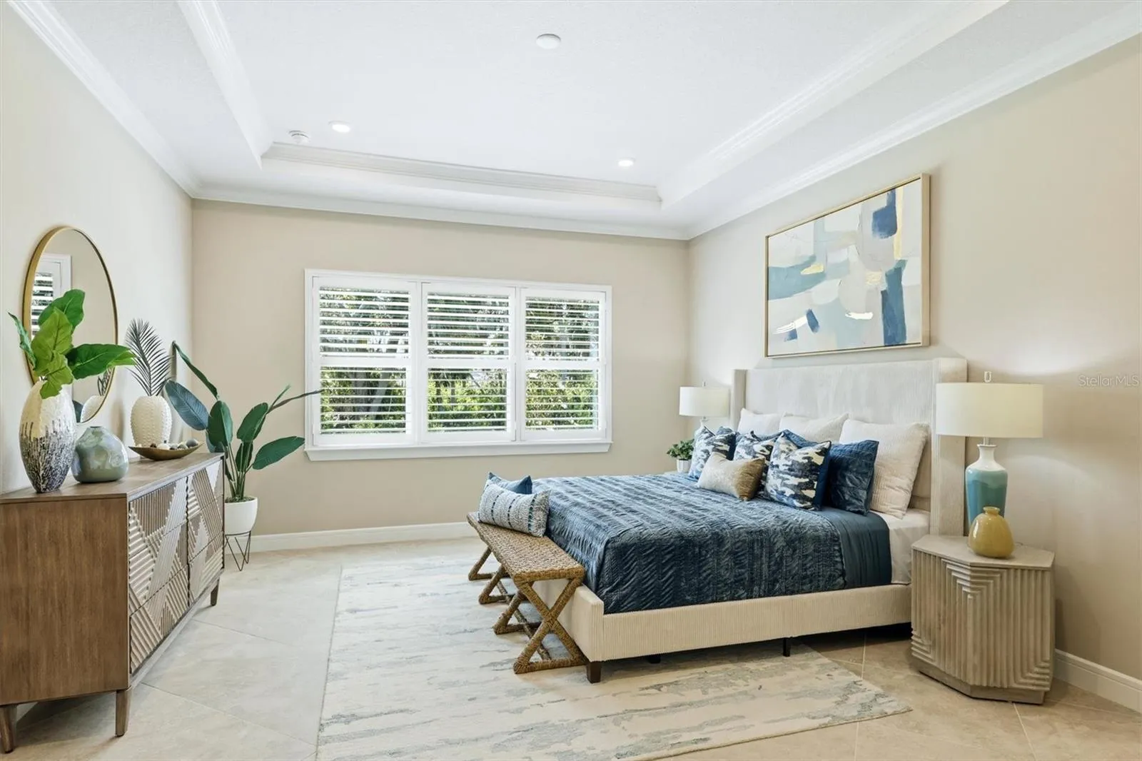 Primary bedroom with coffered ceiling and crown molding
