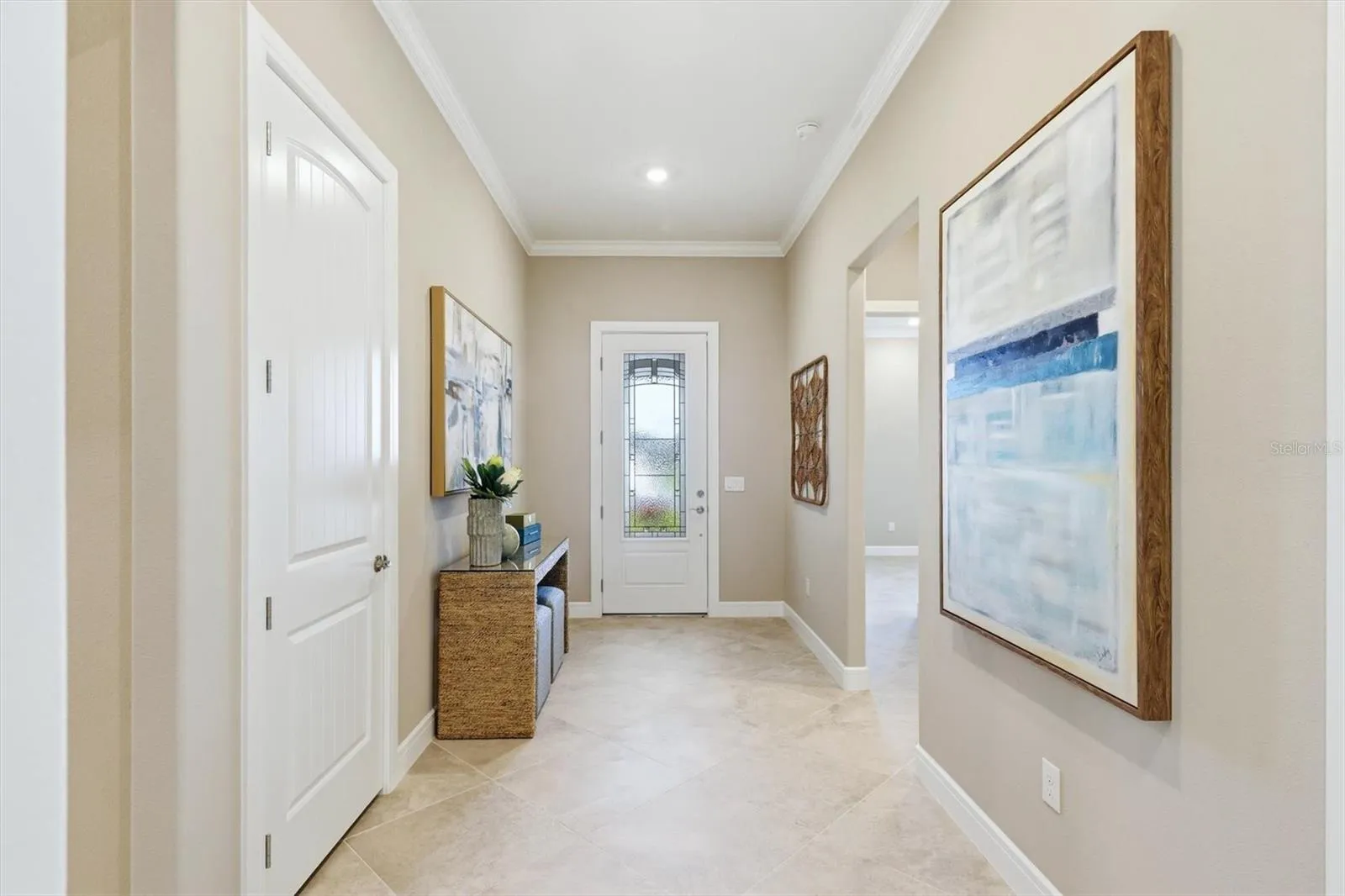 A "Coat" closet. %-1/4 baseboards, 11 ft ceilings and crown molding provide an impressive welcome