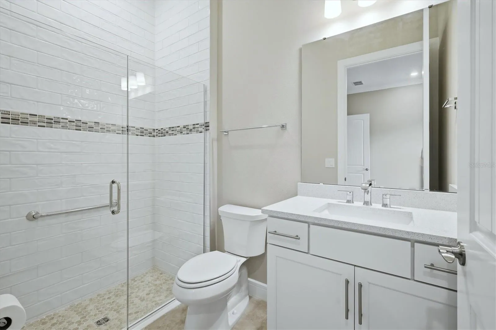 Ensuite guest bath 1- Tile to ceiling and a walk in shower