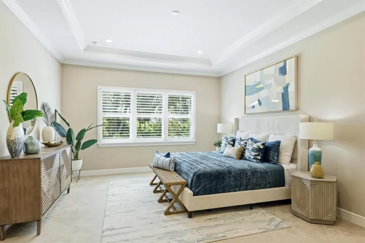 Primary bedroom with coffered ceiling and crown molding