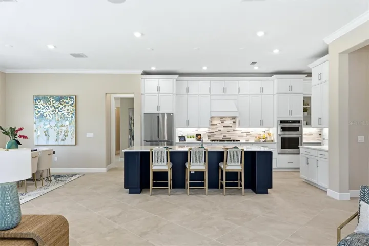 Notice the immense island with two end cap cabinets
