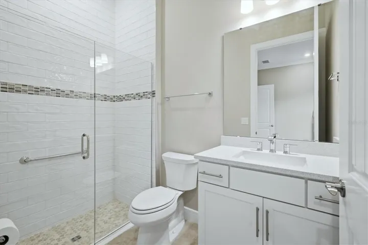 Ensuite guest bath 1- Tile to ceiling and a walk in shower