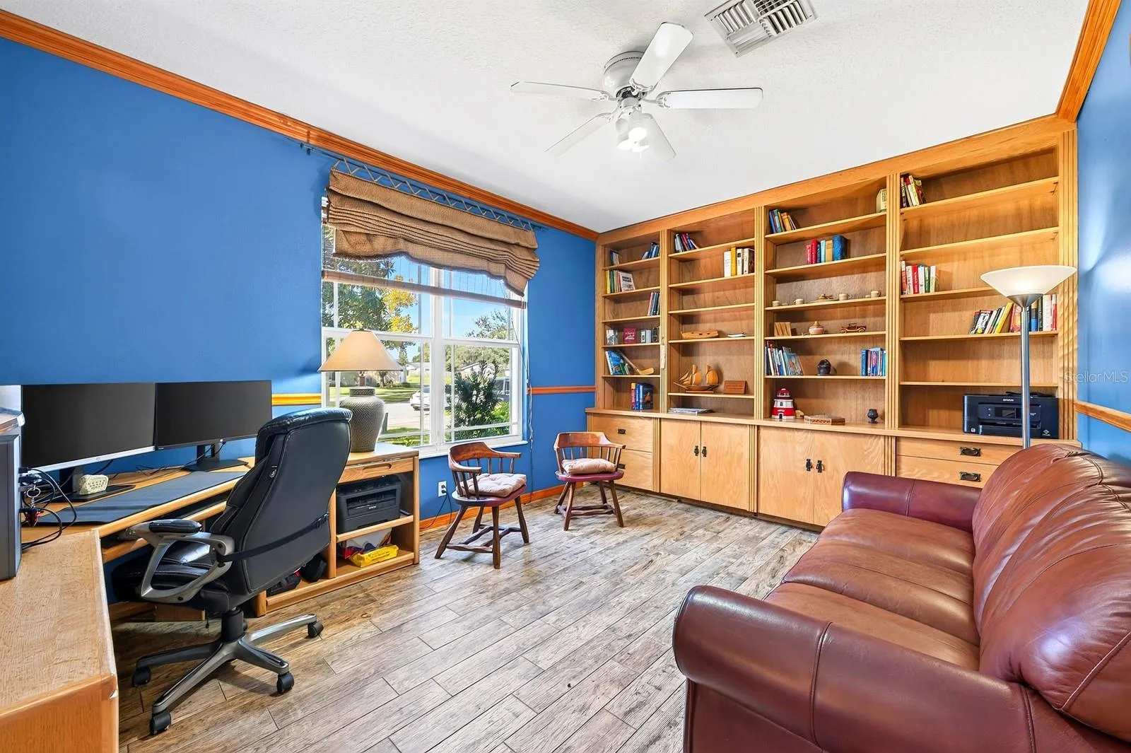 Glass French doors open to a VERSATILE OFFICE or hobby space with built-in shelving, that could also serve as a 5th Bedroom.