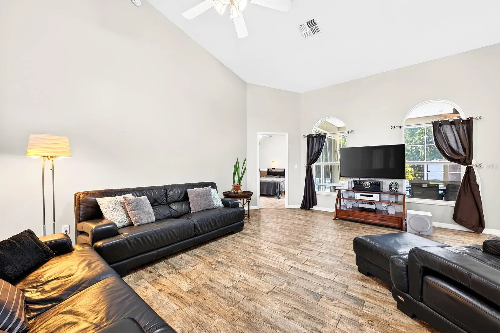 Large windows fill the Living Room with NATURAL LIGHT.
