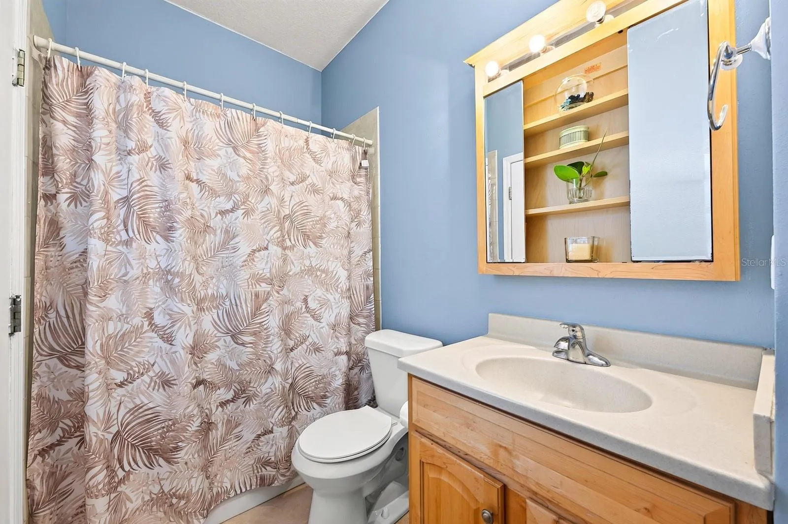 A SECOND FULL BATHROOM includes DIRECT ACCESS TO THE POOL AREA.