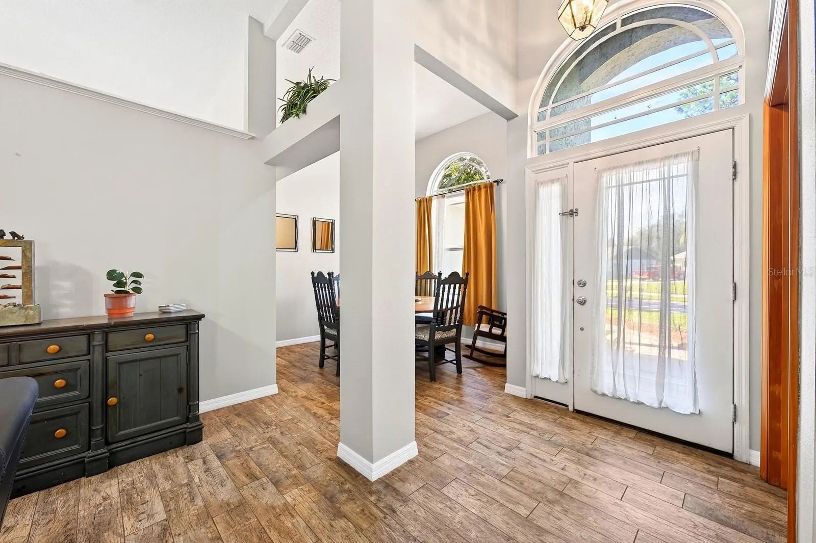 Step inside to cathedral ceilings, graceful architectural details and beautiful WOOD-LOOK TILE FLOORING throughout the main living areas.