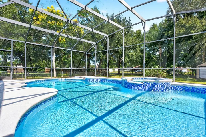 From the attractive CURB APPEAL and mature landscaping to the sparkling INGROUND POOL AND SPA, this exceptional property offers a beautiful setting for relaxed everyday living, memorable gatherings and ENJOYING THE FLORIDA LIFESTYLE.