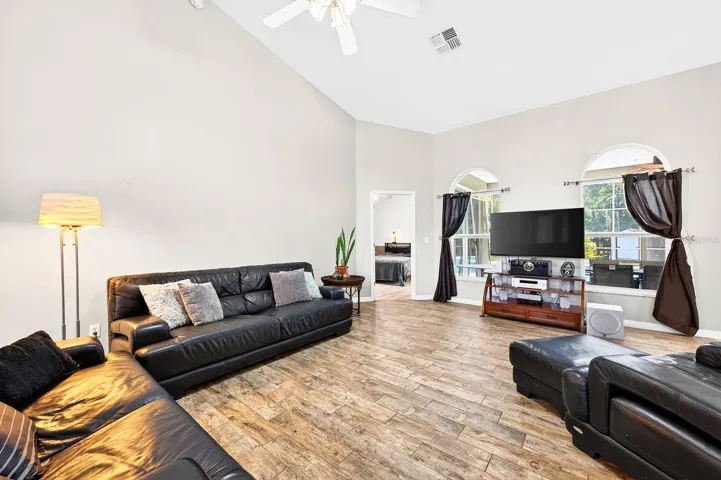 Large windows fill the Living Room with NATURAL LIGHT.