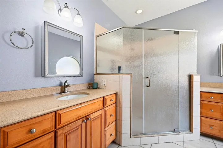The Primary en suite Bath with dual vanities and a walk-in shower with triple showerheads.