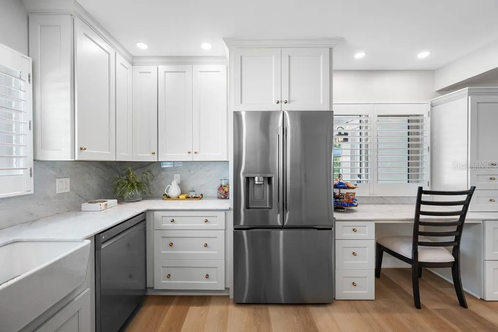 Lots of natural light flows into the kitchen - plantation shutter window treatments