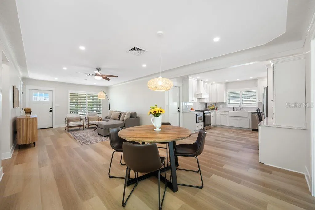 View from dining room showing living room to the left and kitchen to the right