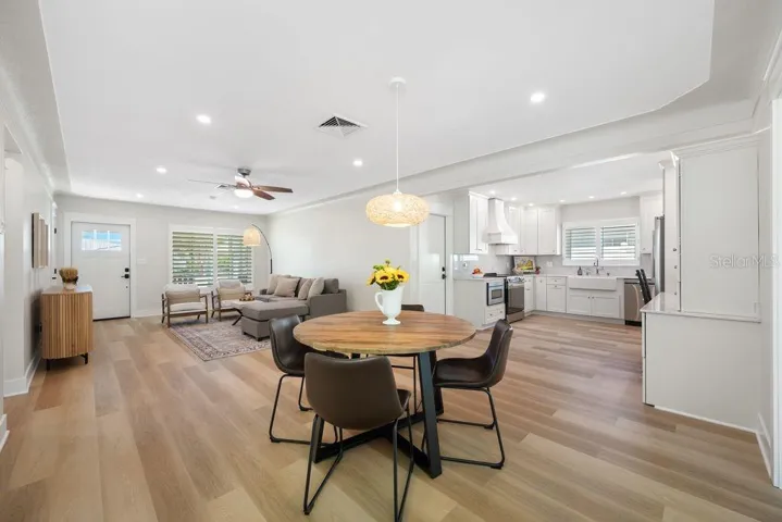 View from dining room showing living room to the left and kitchen to the right