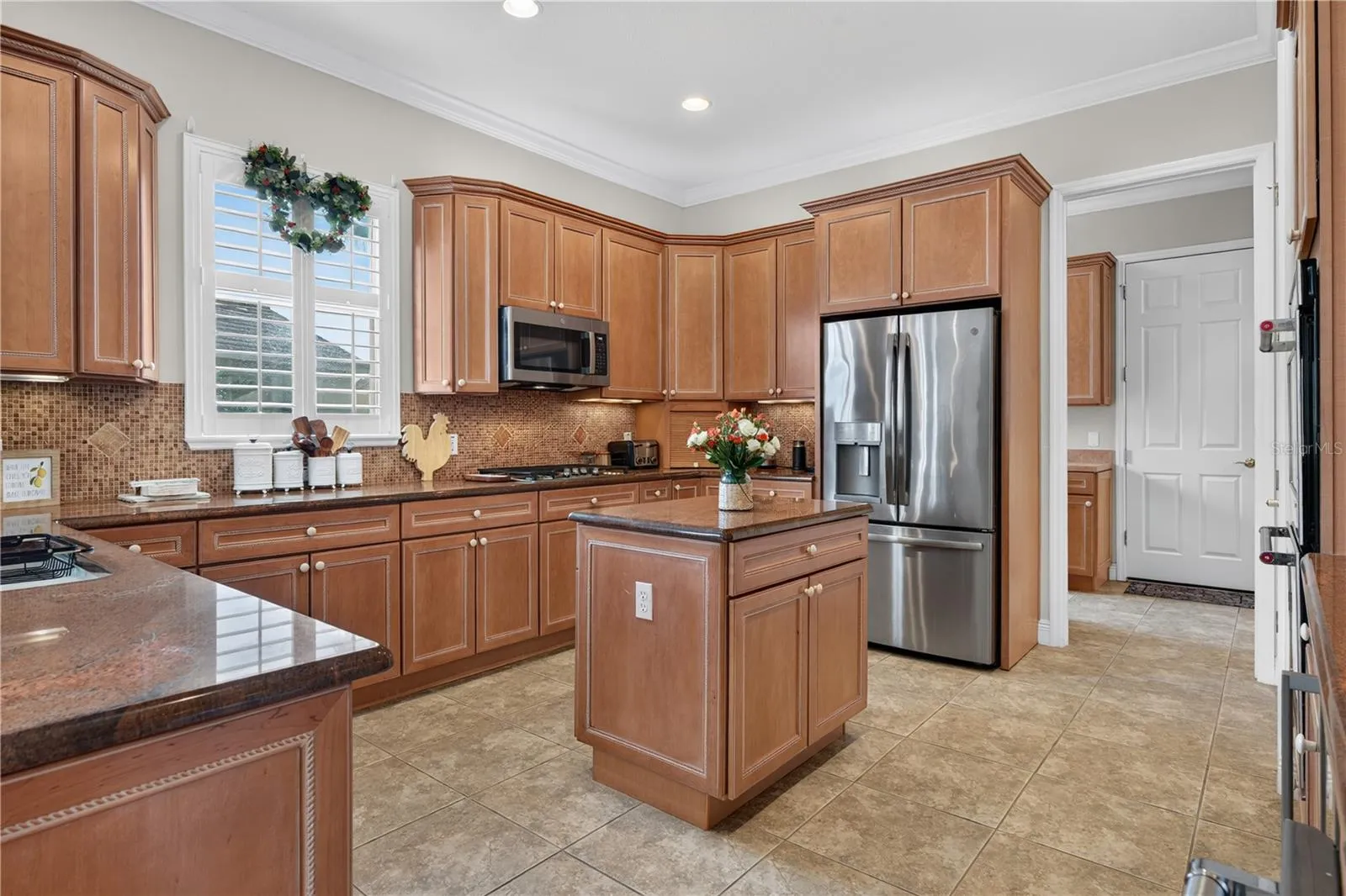 Full View of the Kitchen with Stainless Steel Appliances and Granite Counter Top