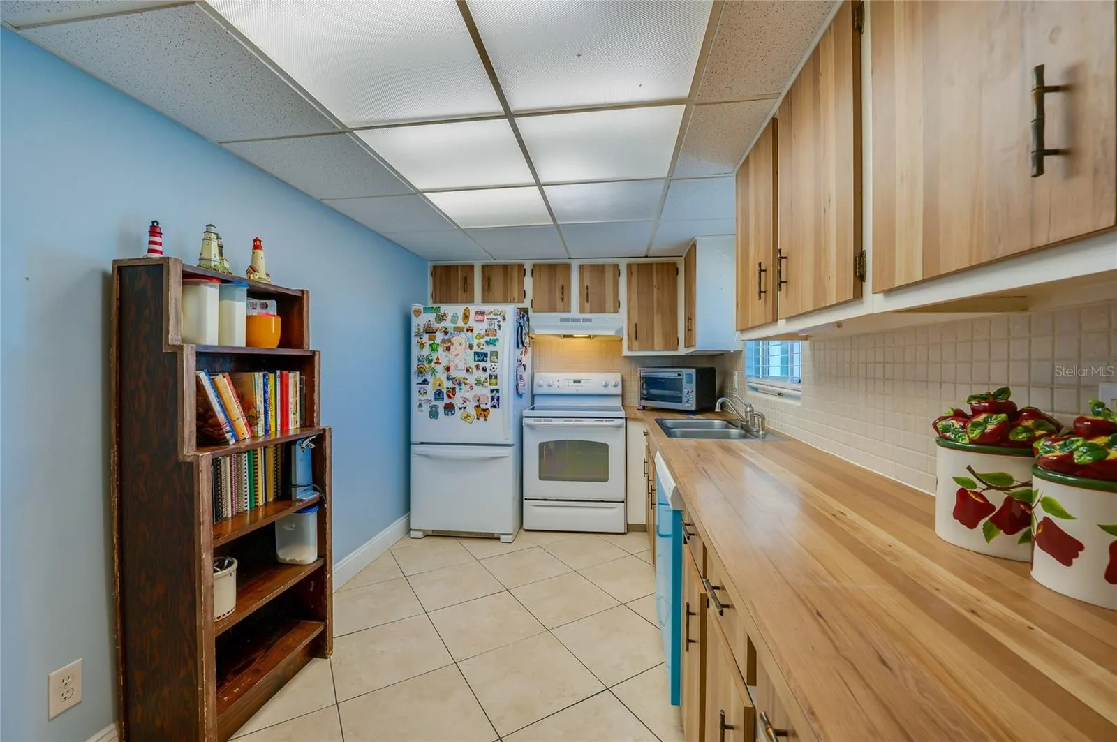 Functional kitchen with wood cabinetry, ample counter space, and a practical layout ideal for everyday meal prep.