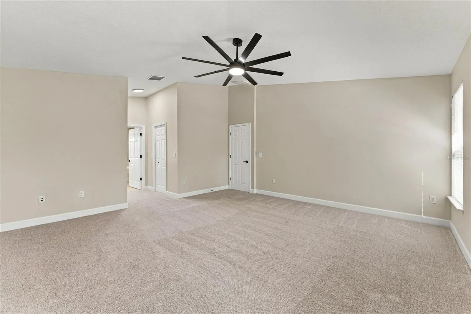 Very large primary bedroom with dual walk in closets