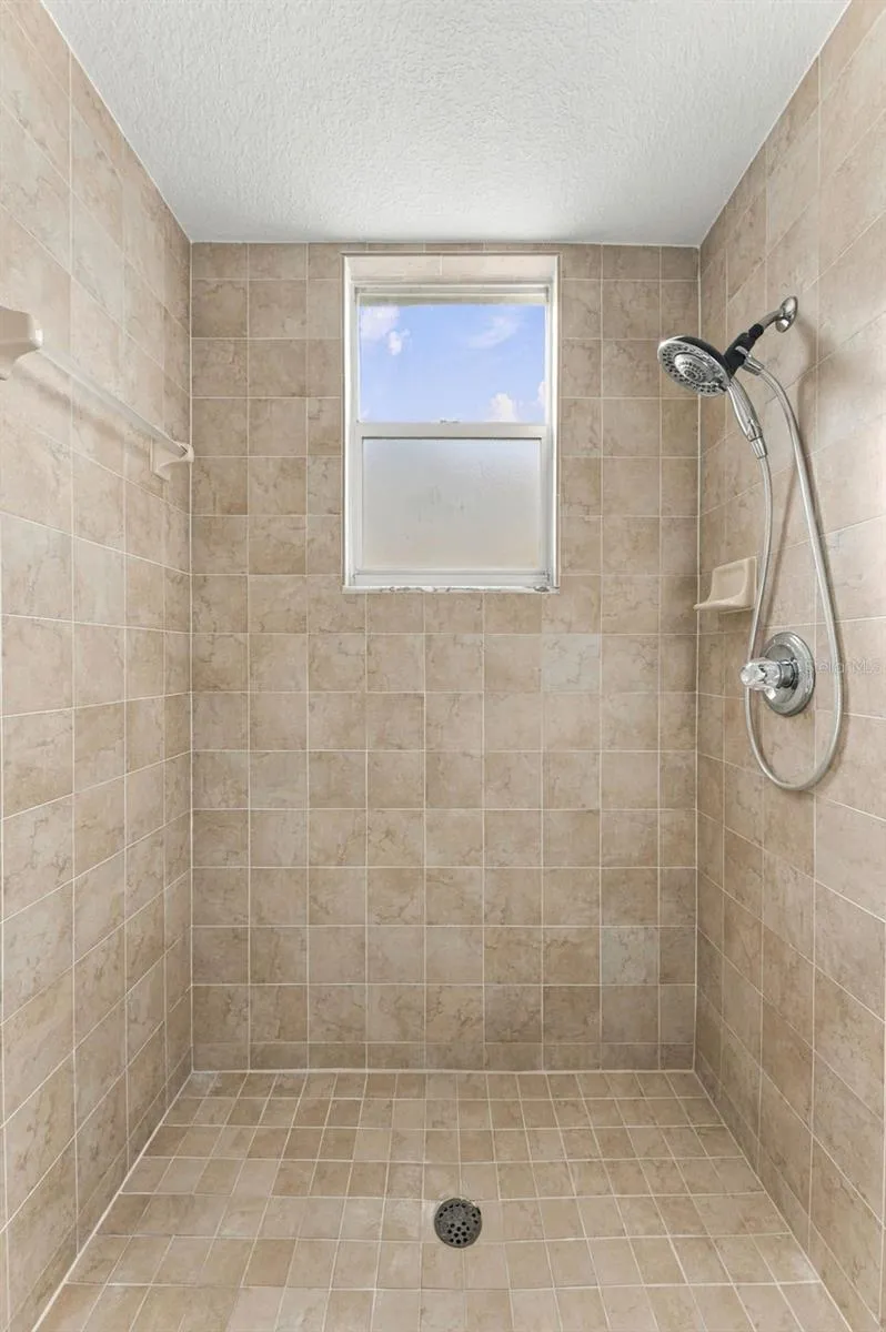 Large shower located in downstairs hall bathroom