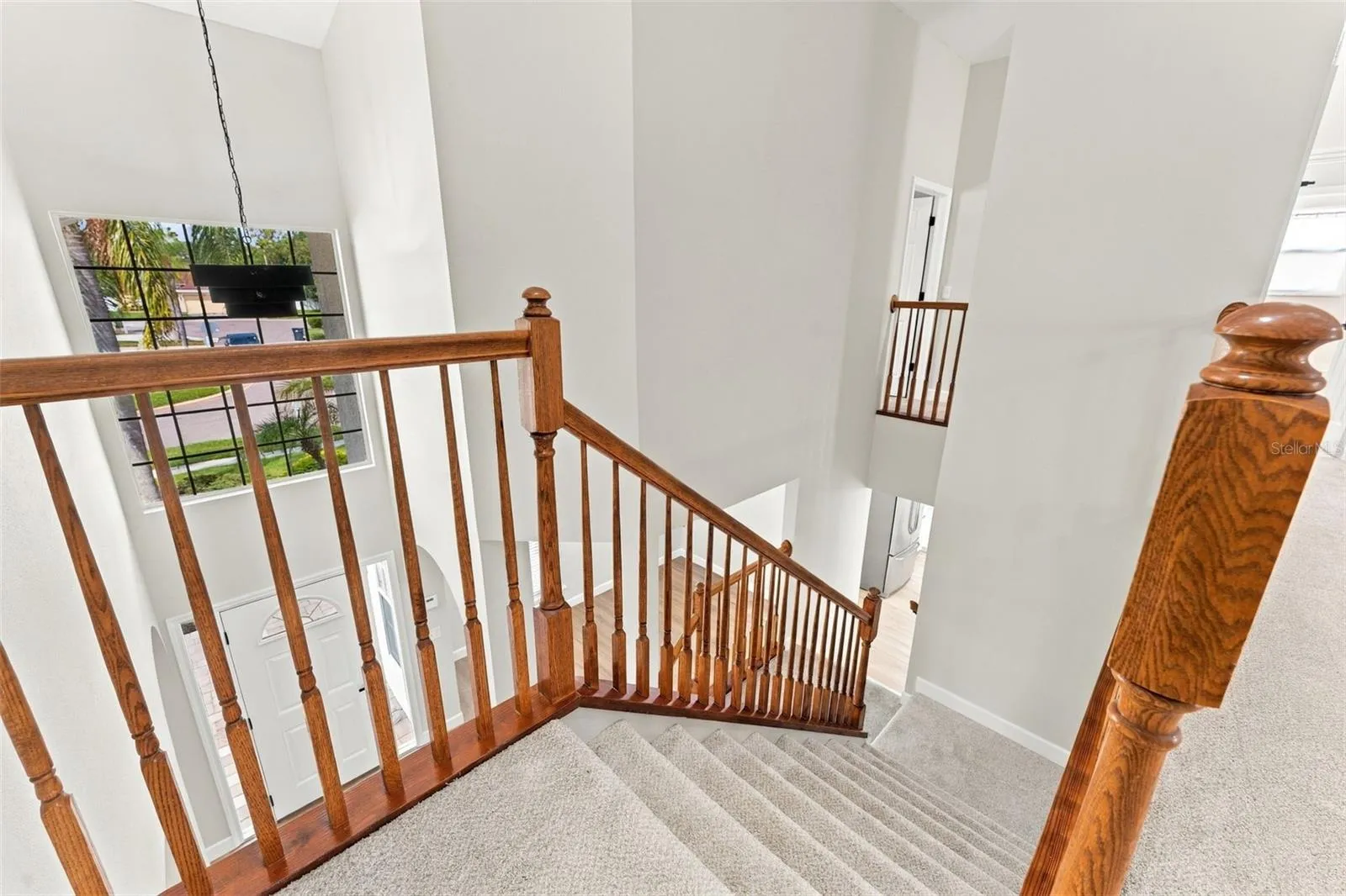 Soaring entryway ceilings highlighted by a beautiful new light fixture