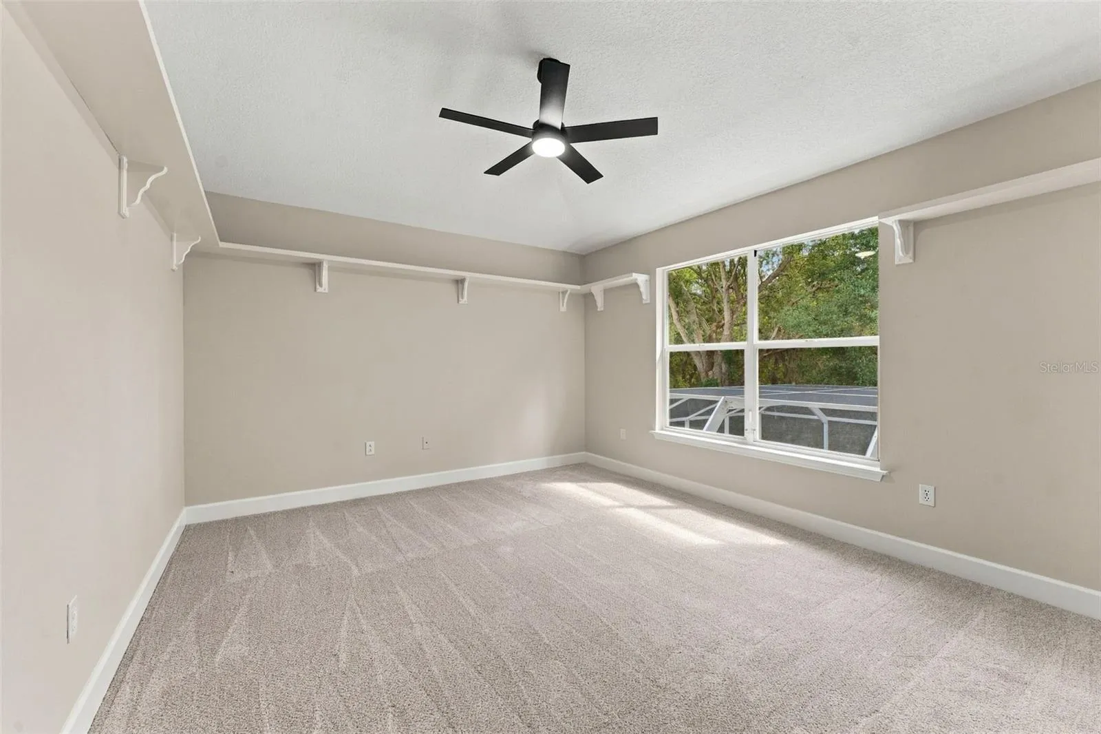 Bedroom 2 located upstairs overlooking the pool cage and woods