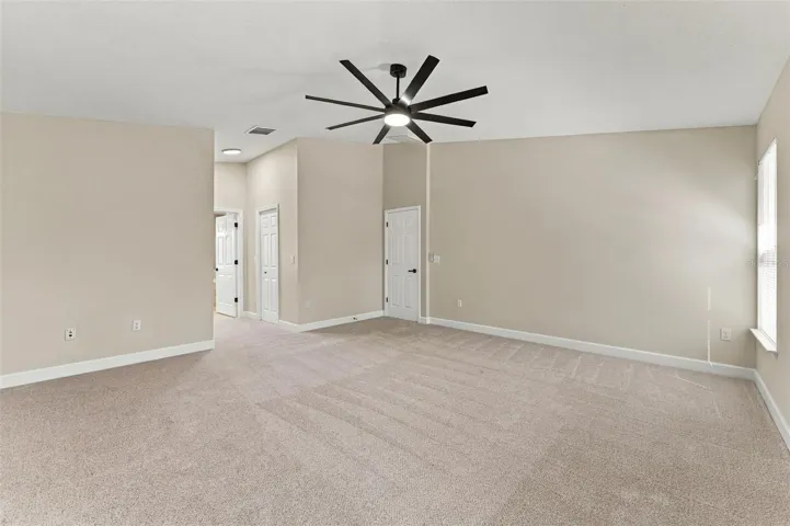 Very large primary bedroom with dual walk in closets