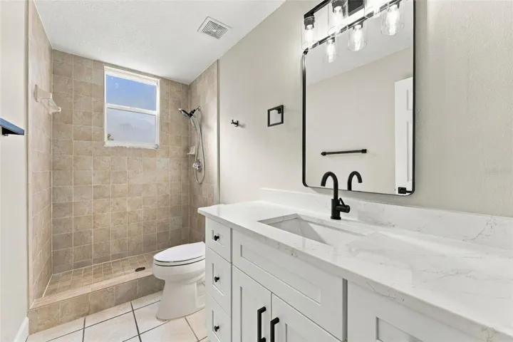 Downstairs hall bathroom with brand new vanity, mirror, lighting and fixtures