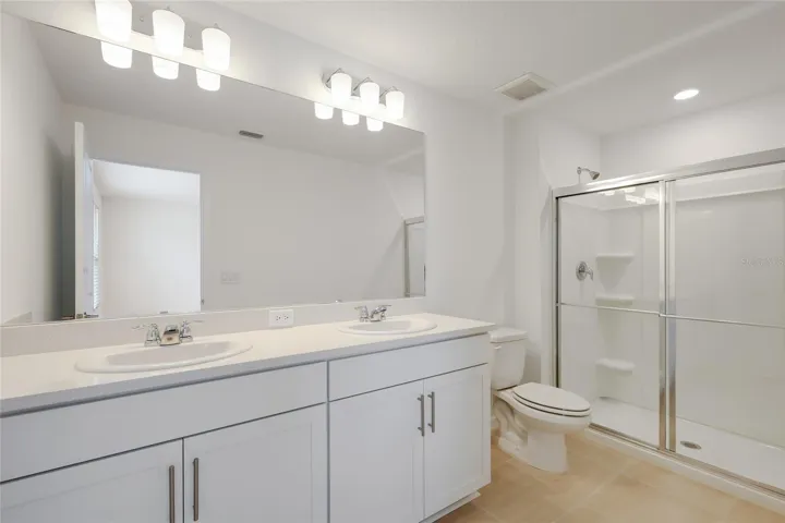 The master bathroom has a large double vanity providing ample space for two people to share to get their day started!