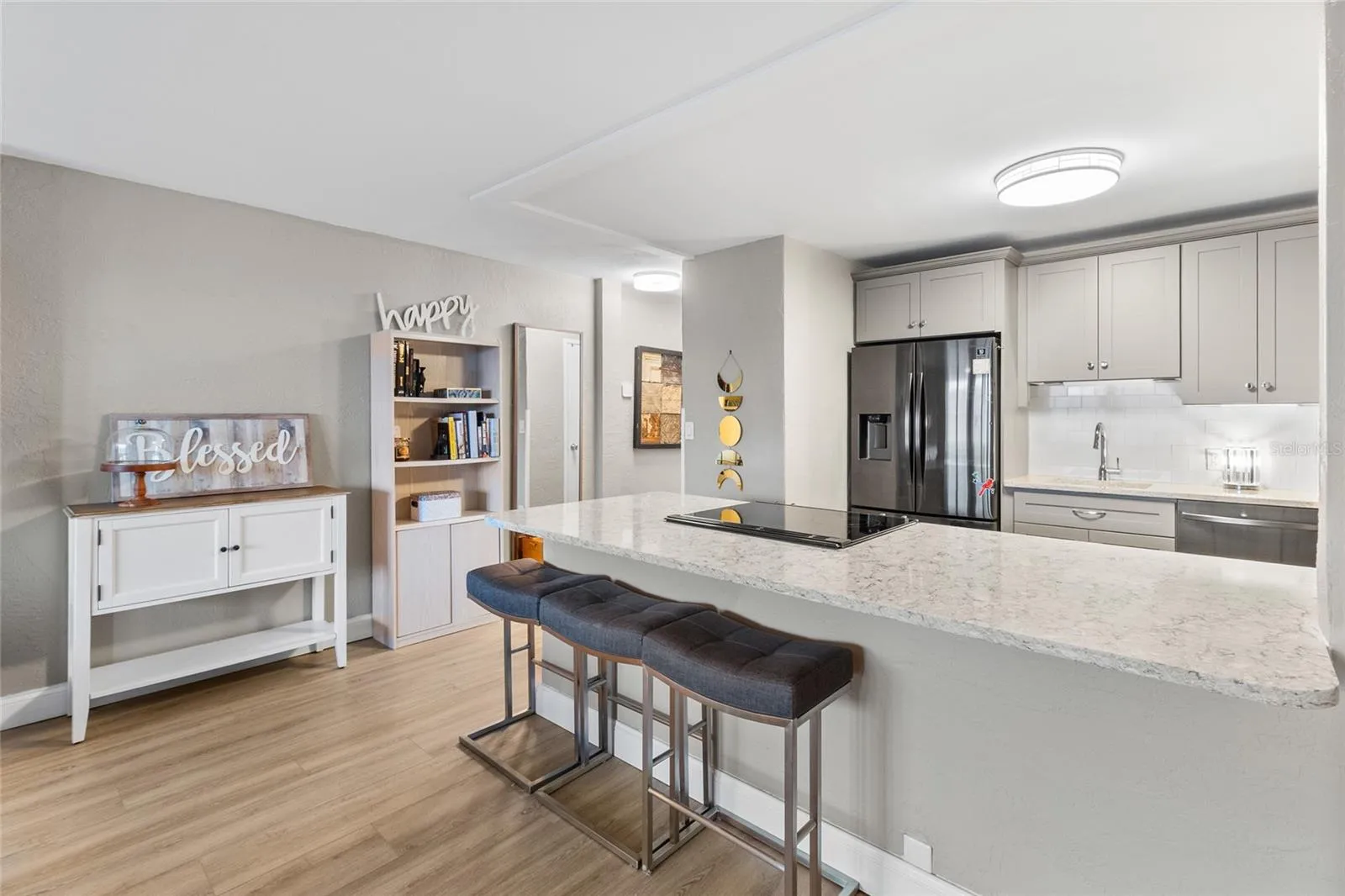 Large quartz counter space open to both kitchen and living area