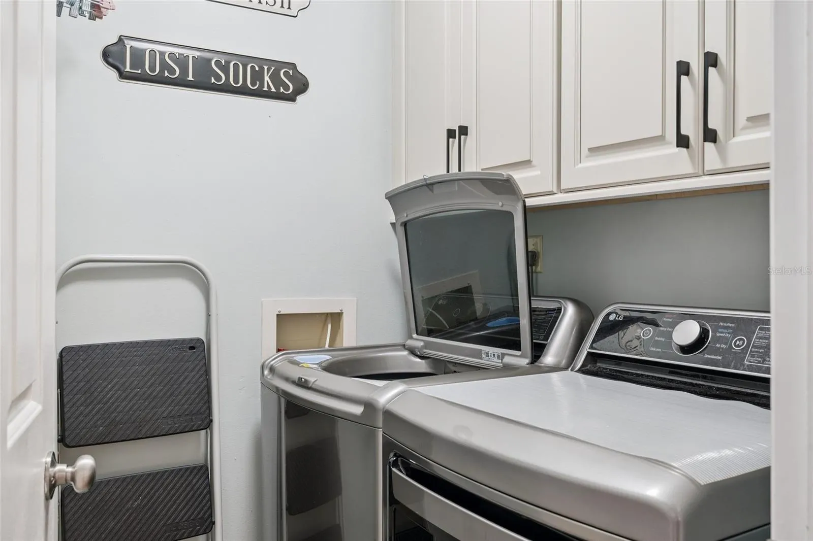 Washer and dryer at end of hallway