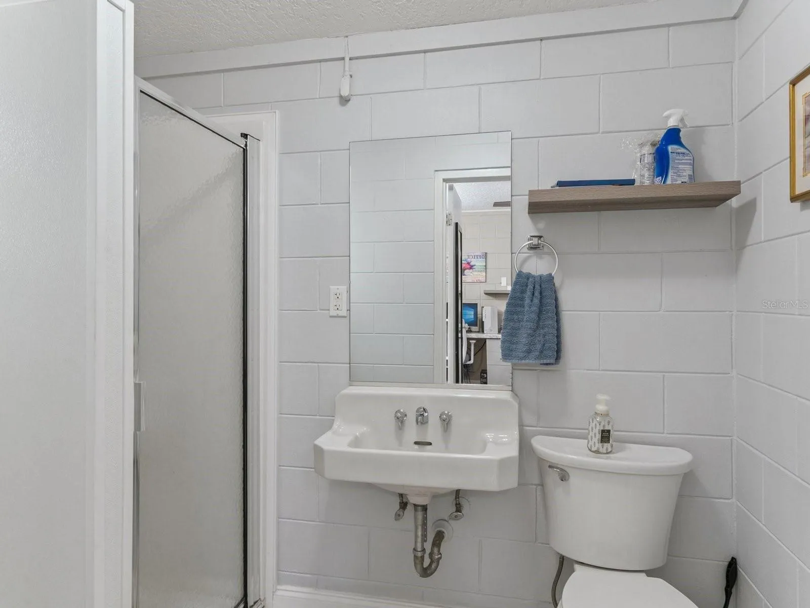Office's private full bathroom with stall shower