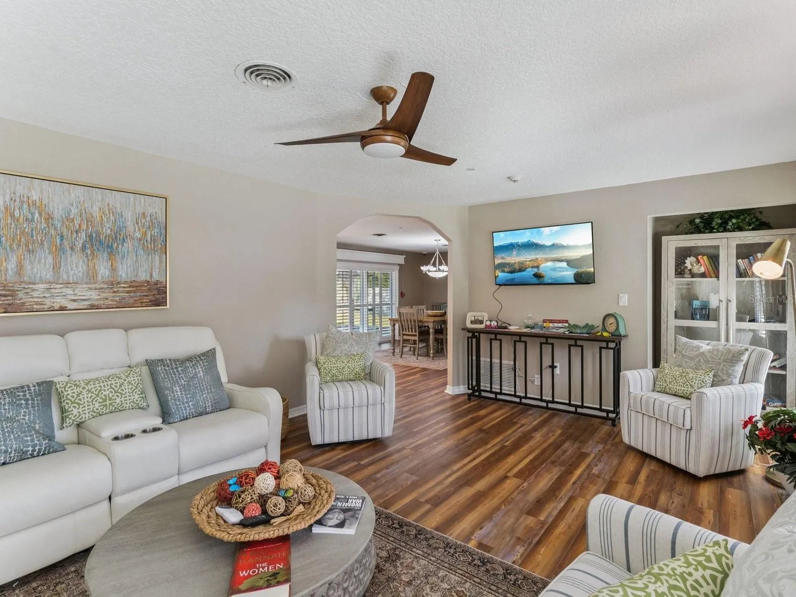 Living room opens to dining through arched doorway