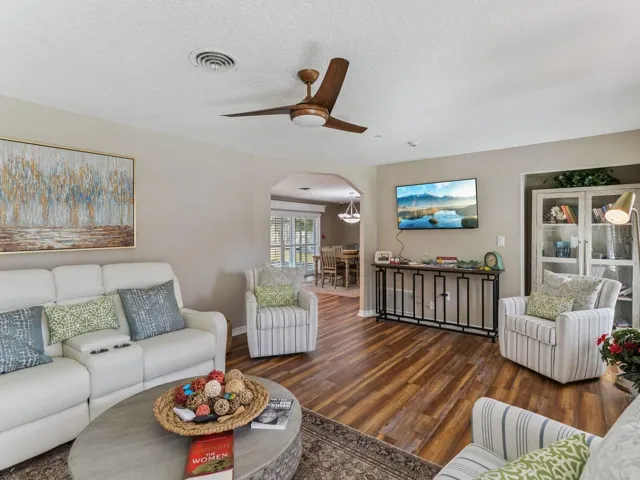 Living room opens to dining through arched doorway
