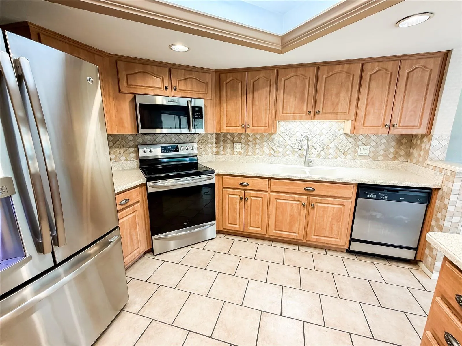 The kitchen is completed with stainless appliances with ample counter top surfaces.